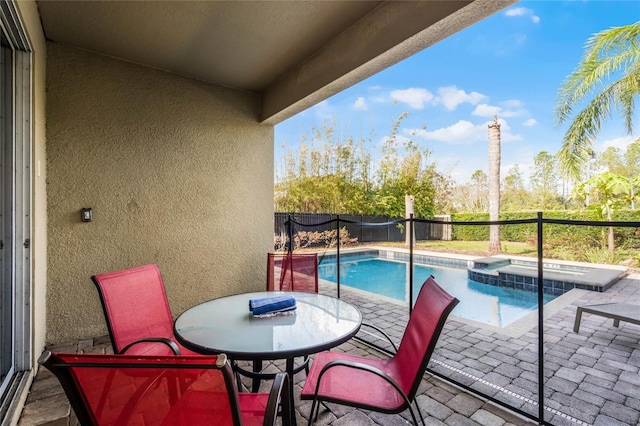 exterior space featuring an in ground hot tub and a patio area