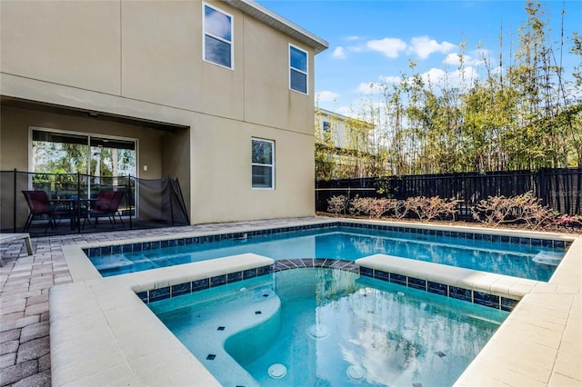 view of pool with an in ground hot tub