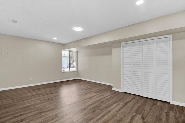 interior space featuring recessed lighting, visible vents, dark wood finished floors, and baseboards