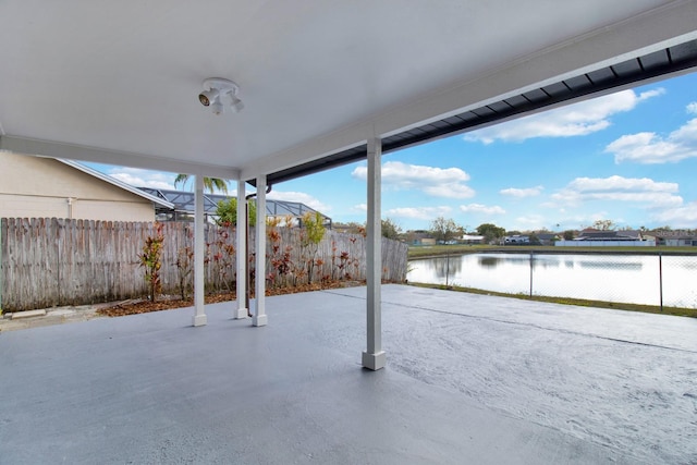 view of patio featuring a water view and a fenced backyard