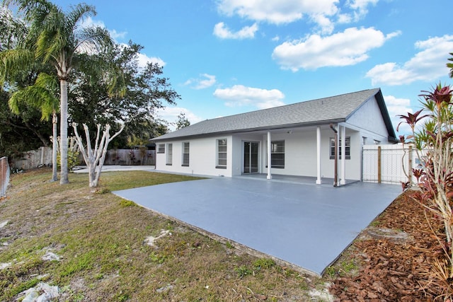 back of property featuring a lawn, a patio area, a fenced backyard, and stucco siding