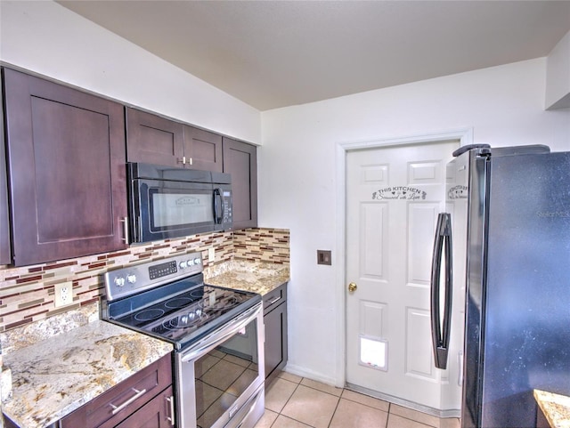 kitchen featuring backsplash, light tile patterned floors, dark brown cabinetry, black appliances, and light stone countertops