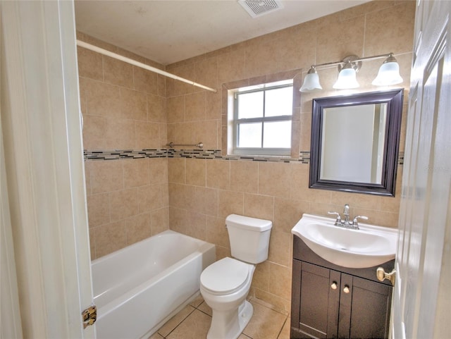 full bathroom with tile walls, vanity, tile patterned floors, and toilet