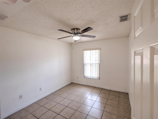 unfurnished room featuring light tile patterned floors, a textured ceiling, and ceiling fan