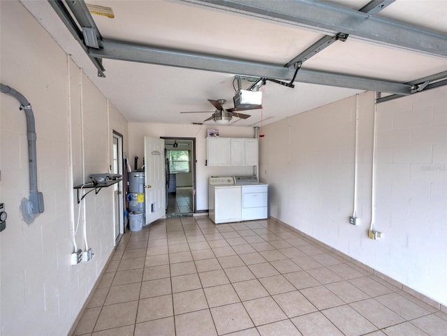 garage with separate washer and dryer, a garage door opener, water heater, and ceiling fan