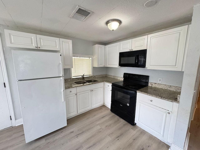 kitchen featuring white cabinetry, sink, and black appliances