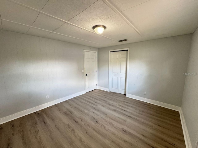 unfurnished bedroom featuring hardwood / wood-style flooring and a closet