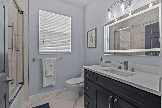 full bathroom with toilet, vanity, and bath / shower combo with glass door