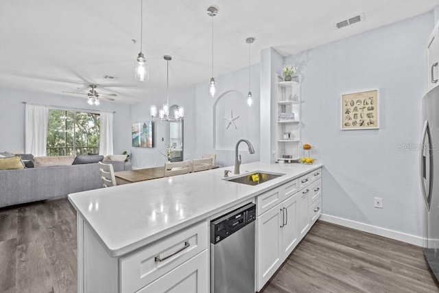 kitchen with appliances with stainless steel finishes, sink, dark wood-type flooring, and white cabinets