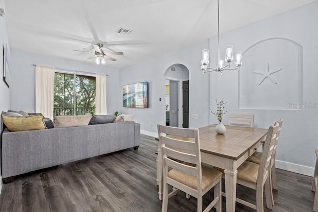 dining space featuring ceiling fan with notable chandelier and dark hardwood / wood-style flooring