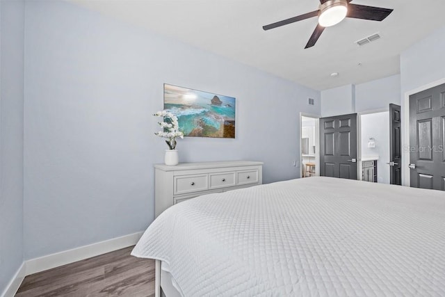 bedroom featuring ensuite bathroom, dark hardwood / wood-style floors, and ceiling fan