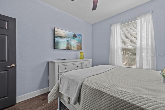 bedroom featuring dark wood-type flooring and ceiling fan