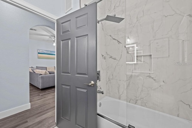 bathroom with tiled shower / bath and wood-type flooring