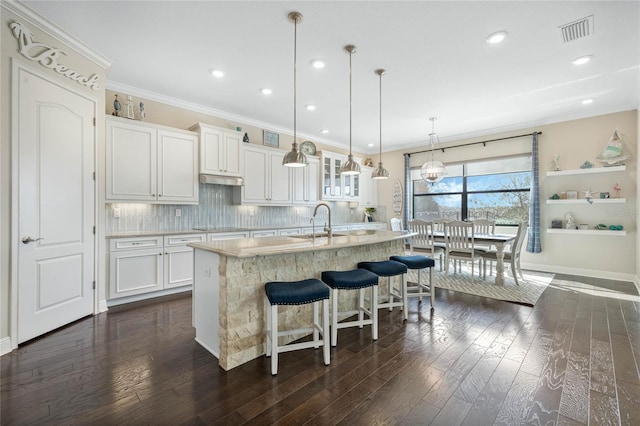 kitchen with visible vents, decorative backsplash, dark wood finished floors, and light countertops