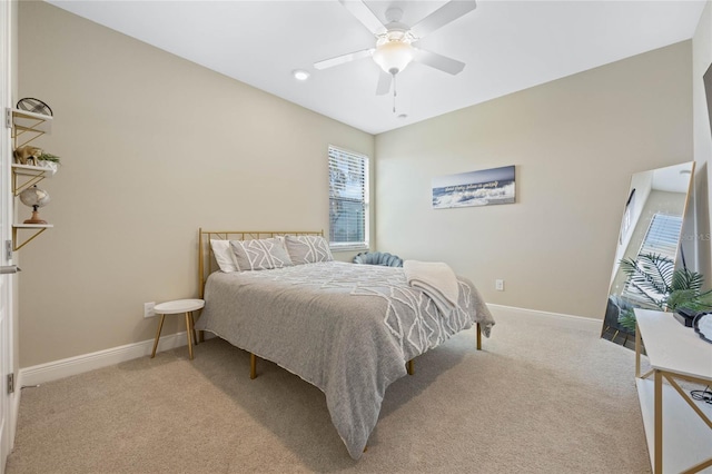 bedroom featuring ceiling fan, baseboards, and light colored carpet