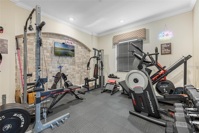 exercise area with brick wall, ornamental molding, and recessed lighting