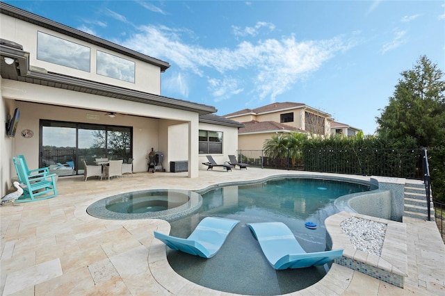 view of swimming pool with a ceiling fan, a pool with connected hot tub, a patio area, and fence