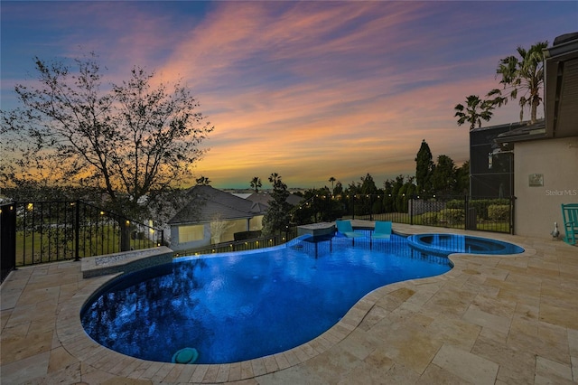 view of pool featuring a patio area, a pool with connected hot tub, and fence