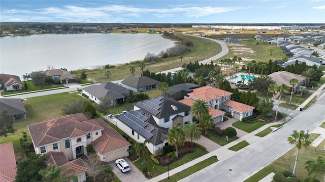 birds eye view of property with a water view and a residential view