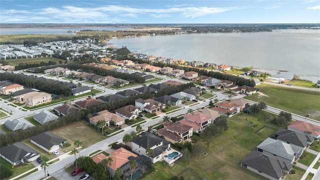 drone / aerial view with a water view and a residential view