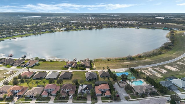 drone / aerial view featuring a water view and a residential view