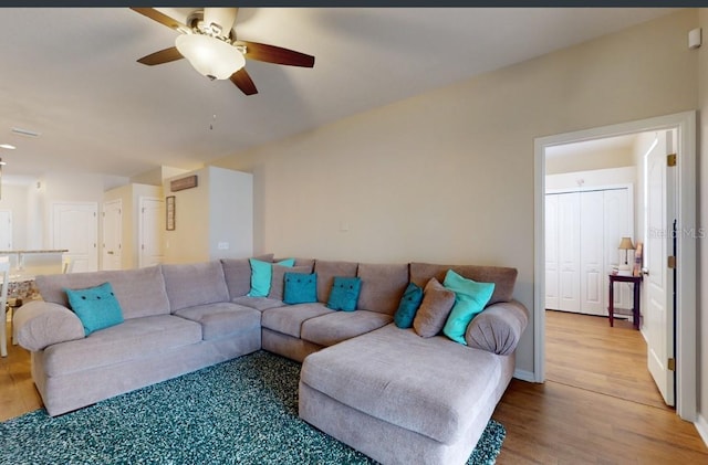 living room featuring hardwood / wood-style floors and ceiling fan