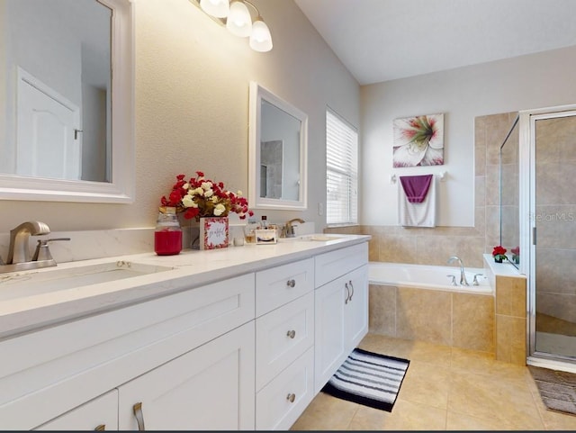 bathroom featuring tile patterned flooring, vanity, and plus walk in shower