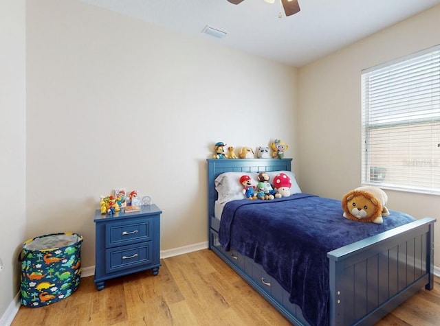 bedroom with light hardwood / wood-style flooring and ceiling fan