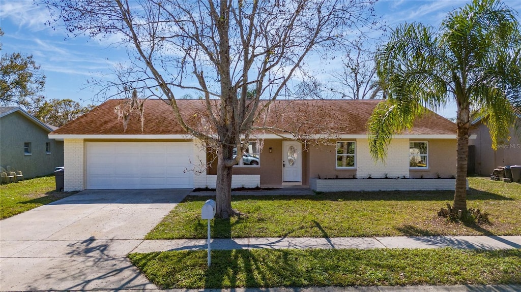 single story home featuring a garage and a front yard