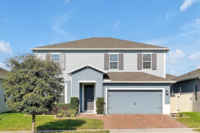 view of front property with a garage and a front lawn