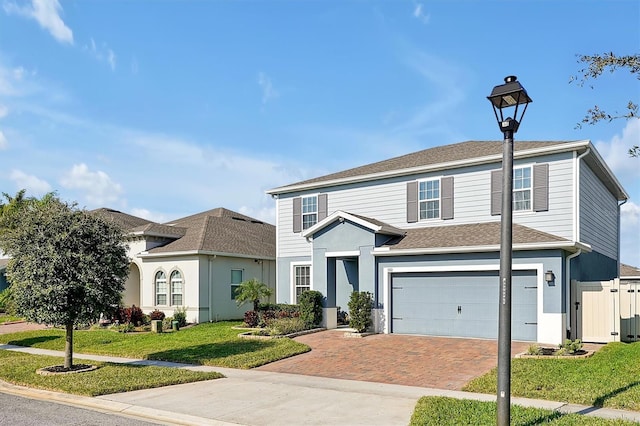 view of front of house with a garage and a front lawn