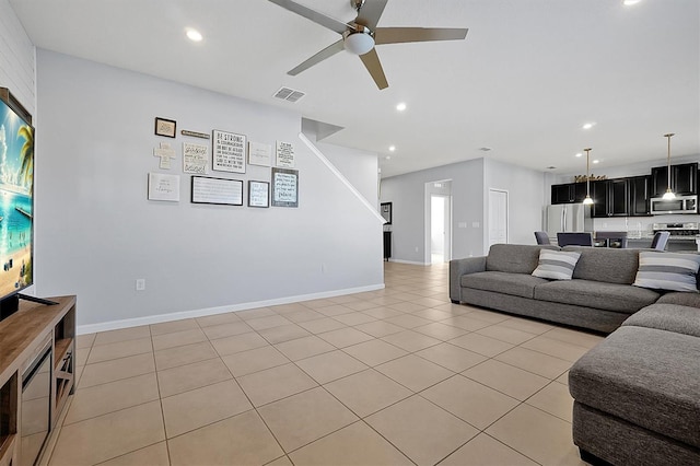 living room featuring light tile patterned floors and ceiling fan