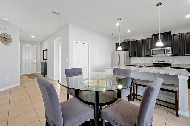 tiled dining room featuring sink