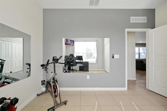 workout area with light tile patterned flooring