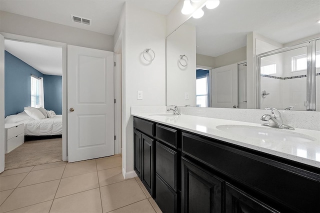 bathroom featuring tile patterned floors, a shower with shower door, vanity, and plenty of natural light