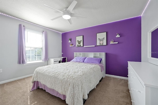 carpeted bedroom featuring ceiling fan and a textured ceiling