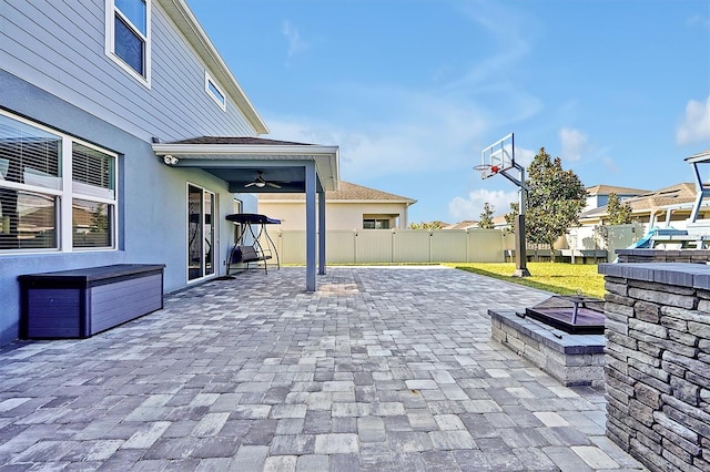 view of patio / terrace with ceiling fan, an outdoor fire pit, and a playground