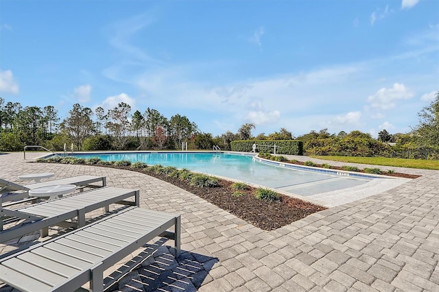 view of pool featuring a patio