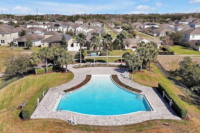 view of pool featuring a lawn