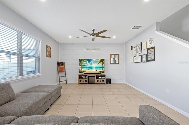 tiled living room with ceiling fan