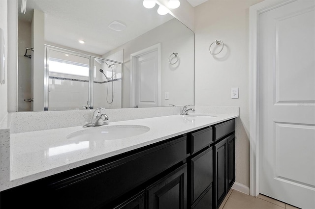 bathroom with vanity, tile patterned flooring, and a shower with shower door