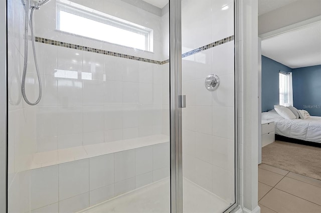 bathroom with tile patterned floors and a shower with shower door