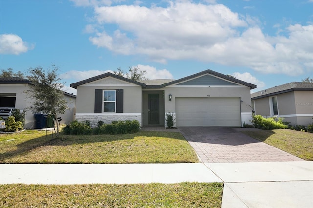 ranch-style house featuring a garage and a front lawn