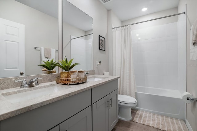 full bathroom featuring shower / bathtub combination with curtain, vanity, hardwood / wood-style floors, and toilet