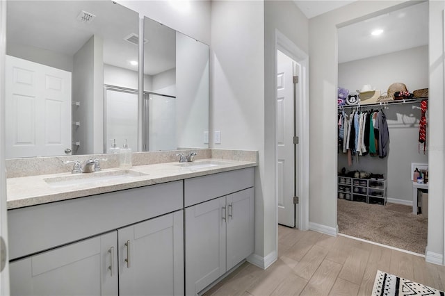 bathroom with vanity, hardwood / wood-style floors, and walk in shower