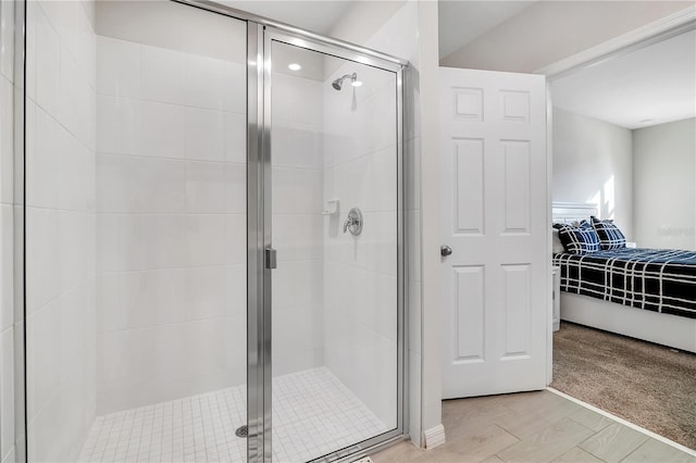 bathroom featuring hardwood / wood-style floors and walk in shower