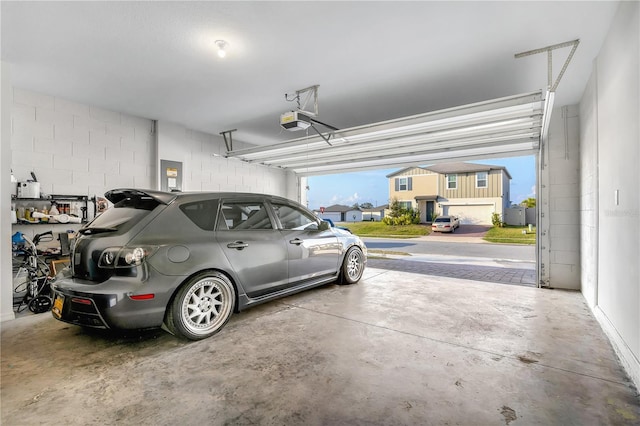 garage featuring a garage door opener and electric panel