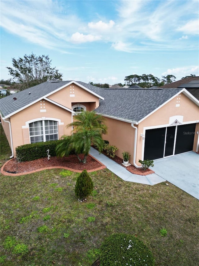 single story home with a garage and a front lawn