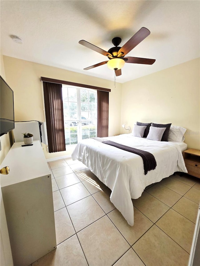 tiled bedroom featuring ceiling fan