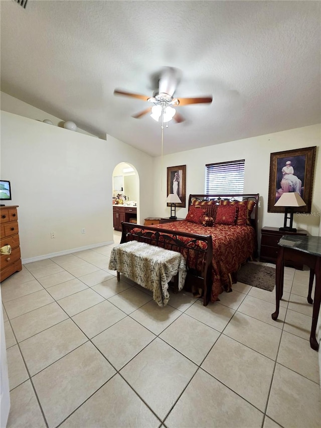 tiled bedroom featuring ceiling fan and a textured ceiling